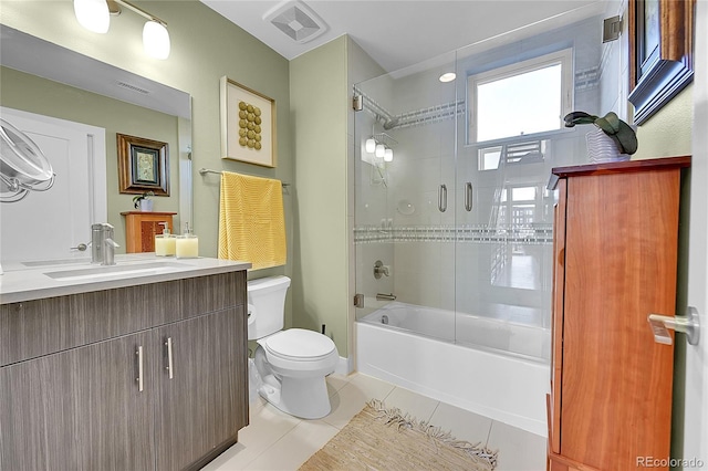 full bathroom featuring tile patterned flooring, vanity, shower / bath combination with glass door, and toilet