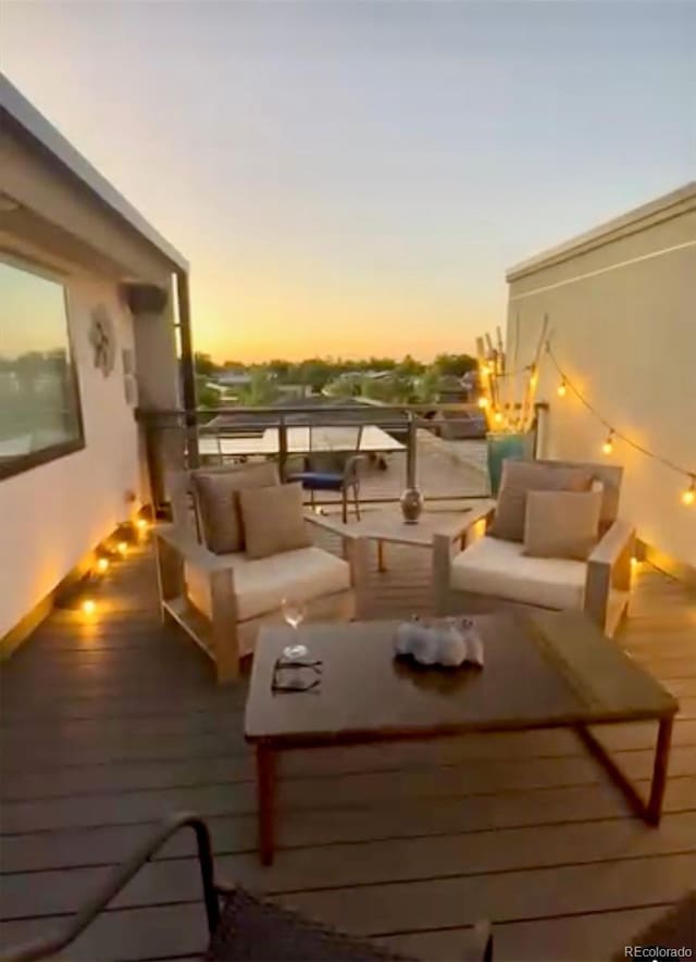 deck at dusk with outdoor lounge area