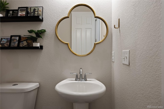 bathroom featuring sink and toilet