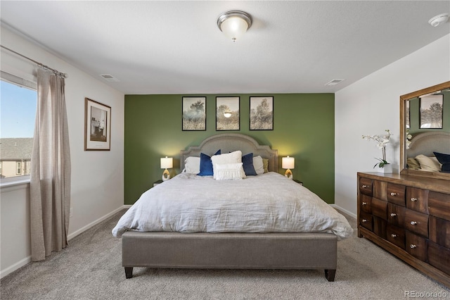 bedroom with light carpet and multiple windows