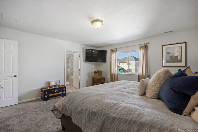 carpeted bedroom featuring ensuite bath