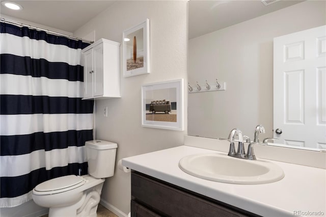 bathroom with toilet, vanity, and curtained shower