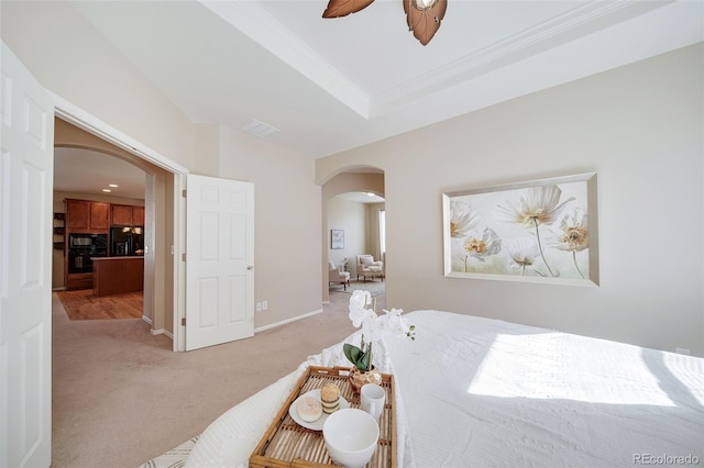 bedroom with light colored carpet, arched walkways, a ceiling fan, baseboards, and black fridge with ice dispenser