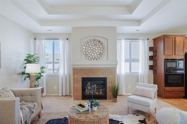 12340 Syracuse St, Thornton, CO 80602 - living area with a raised ceiling, healthy amount of natural light, a tile fireplace, and ornamental molding