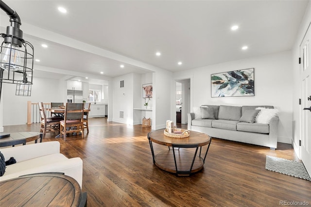 living room with dark hardwood / wood-style floors