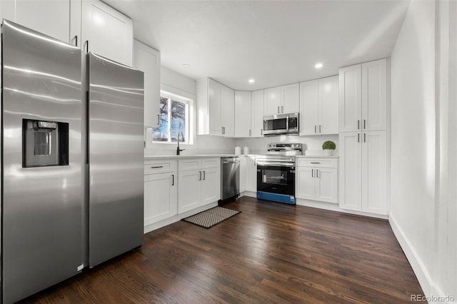 kitchen featuring white cabinets, dark hardwood / wood-style floors, sink, and stainless steel appliances