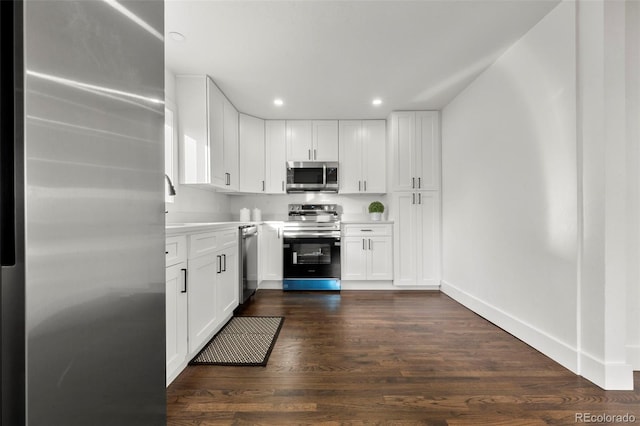 kitchen featuring white cabinets, stainless steel appliances, and dark hardwood / wood-style floors