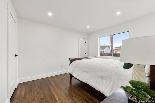 bedroom with dark hardwood / wood-style flooring