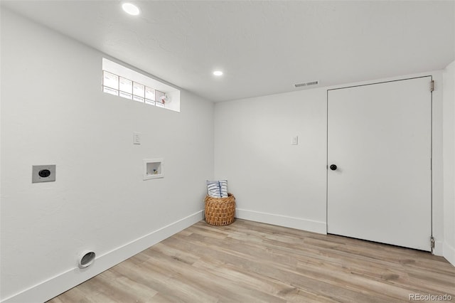 washroom featuring hookup for an electric dryer, washer hookup, and light hardwood / wood-style flooring