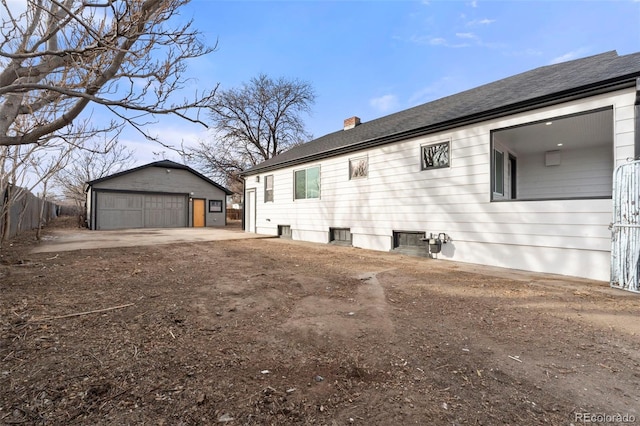 view of side of home with a garage and an outdoor structure