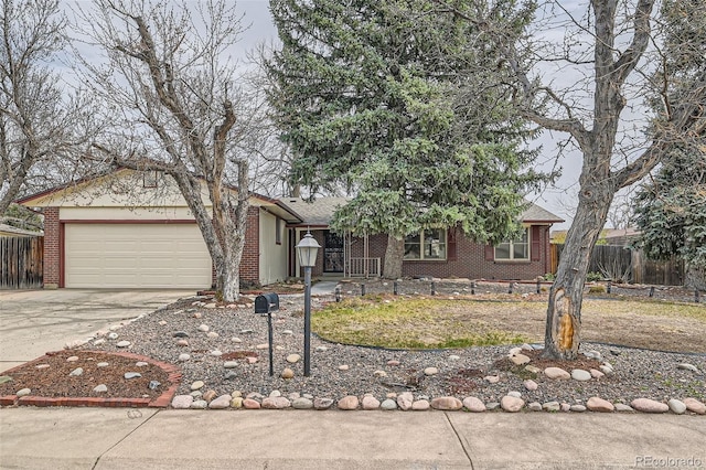 view of front of home with fence, brick siding, a garage, and concrete driveway