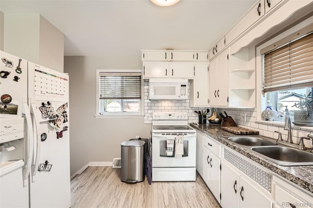 7060 Avrum Dr, Denver, CO 80221 - kitchen with white appliances, a sink, decorative backsplash, and white cabinets