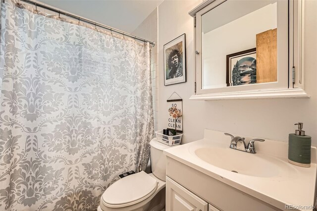7060 Avrum Dr, Denver, CO 80221 - full bathroom with toilet, vanity, and curtained shower