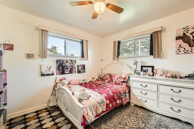 7060 Avrum Dr, Denver, CO 80221 - bedroom with multiple windows, baseboards, and ceiling fan