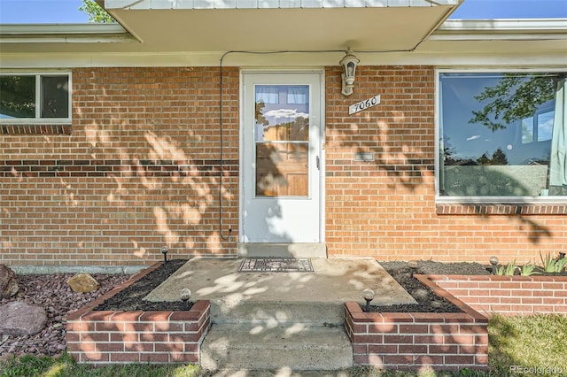 7060 Avrum Dr, Denver, CO 80221 - view of exterior entry featuring brick siding