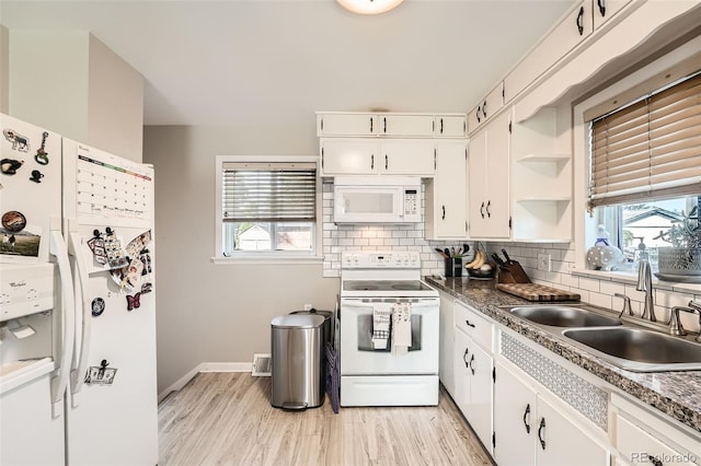 7060 Avrum Dr, Denver, CO 80221 - kitchen with white appliances, tasteful backsplash, white cabinets, and healthy amount of natural light