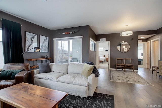 living room featuring visible vents and wood finished floors