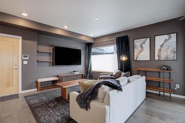 living room with recessed lighting, baseboards, and wood finished floors