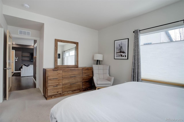 carpeted bedroom with visible vents