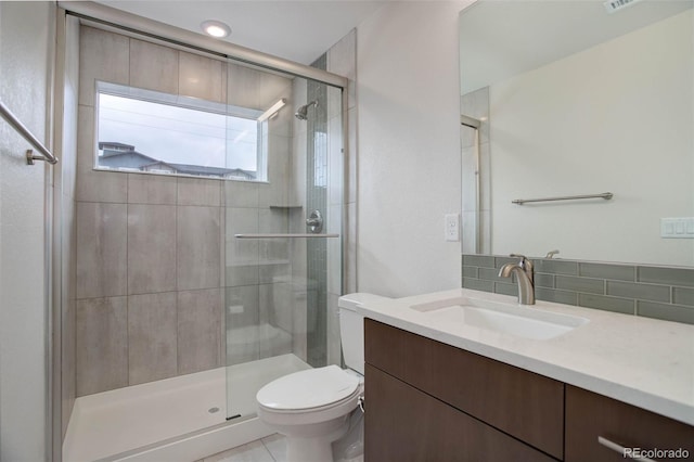 full bathroom featuring decorative backsplash, a shower stall, toilet, and vanity