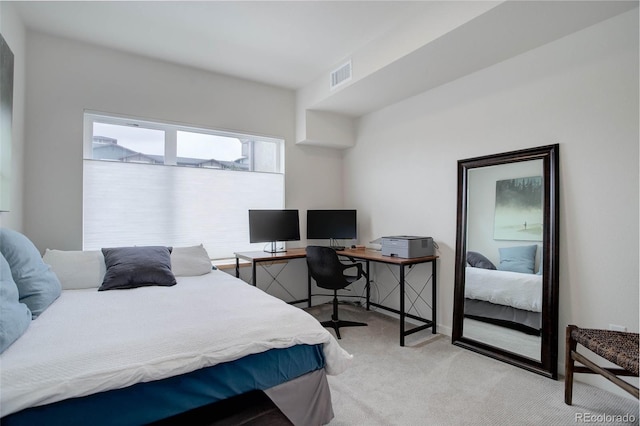 carpeted bedroom featuring visible vents