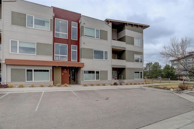 view of building exterior featuring uncovered parking