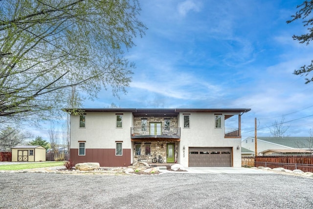 822 Yale Ave, Buena Vista, CO 81211 - view of front of house featuring a balcony, fence, a shed, an attached garage, and driveway