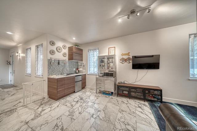 822 Yale Ave, Buena Vista, CO 81211 - kitchen with light countertops, brown cabinets, refrigerator, a sink, and baseboards