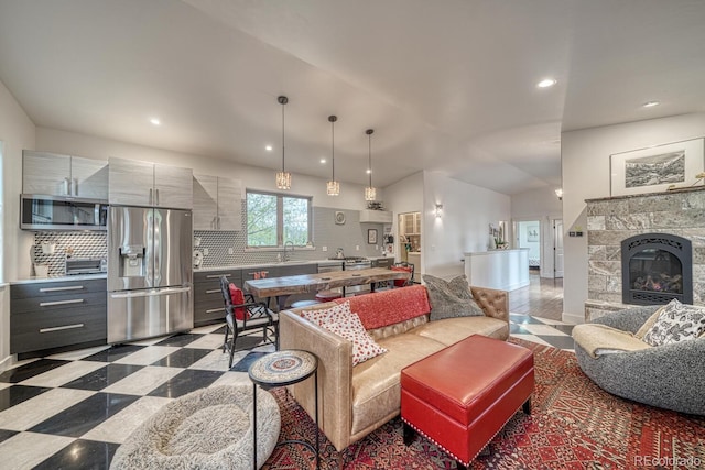 822 Yale Ave, Buena Vista, CO 81211 - living room featuring vaulted ceiling, recessed lighting, a glass covered fireplace, and light floors