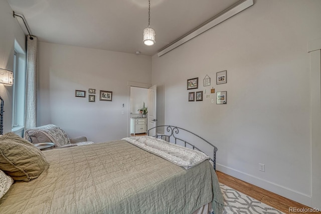 822 Yale Ave, Buena Vista, CO 81211 - bedroom with wood finished floors, baseboards, and lofted ceiling