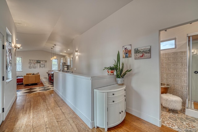 822 Yale Ave, Buena Vista, CO 81211 - hall with hardwood / wood-style floors, healthy amount of natural light, lofted ceiling, and baseboards