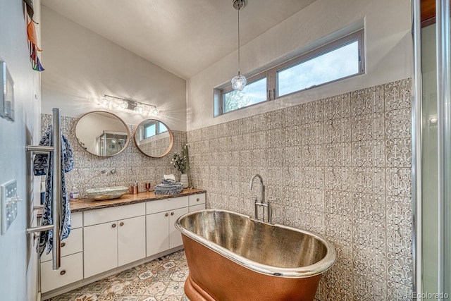 822 Yale Ave, Buena Vista, CO 81211 - full bathroom with tile walls, healthy amount of natural light, vanity, a soaking tub, and decorative backsplash