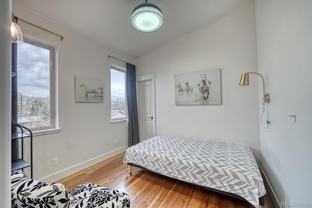 822 Yale Ave, Buena Vista, CO 81211 - bedroom featuring wood-type flooring, multiple windows, baseboards, and lofted ceiling