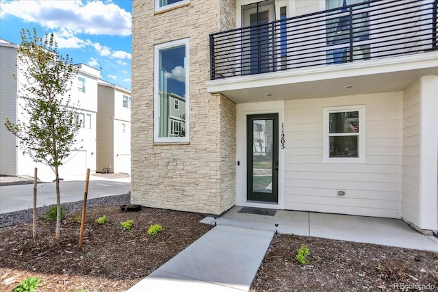 11205 W 53rd Ln, Arvada, CO 80002 - entrance to property featuring stone siding and a balcony