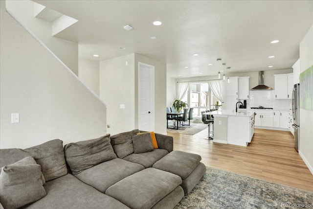 11205 W 53rd Ln, Arvada, CO 80002 - living room with light wood finished floors, recessed lighting, and stairs