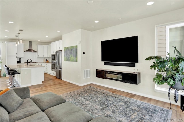 11205 W 53rd Ln, Arvada, CO 80002 - living room featuring light wood-type flooring, recessed lighting, and baseboards
