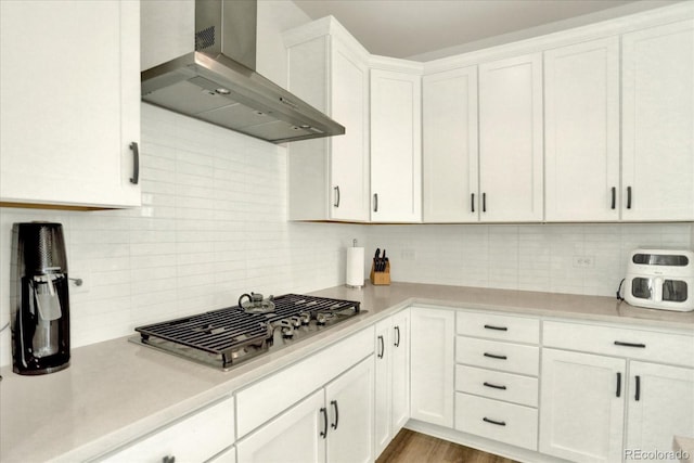 11205 W 53rd Ln, Arvada, CO 80002 - kitchen with wall chimney exhaust hood, stainless steel gas cooktop, decorative backsplash, and light countertops
