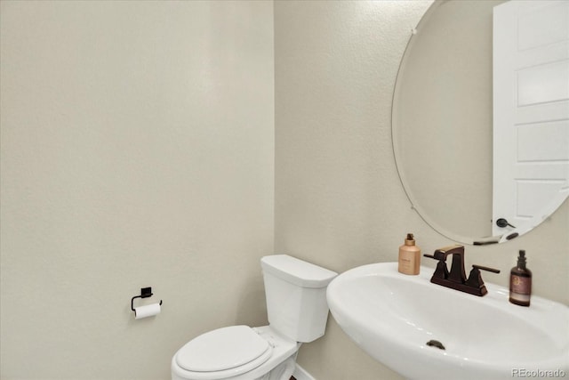 11205 W 53rd Ln, Arvada, CO 80002 - bathroom with a sink, toilet, and baseboards