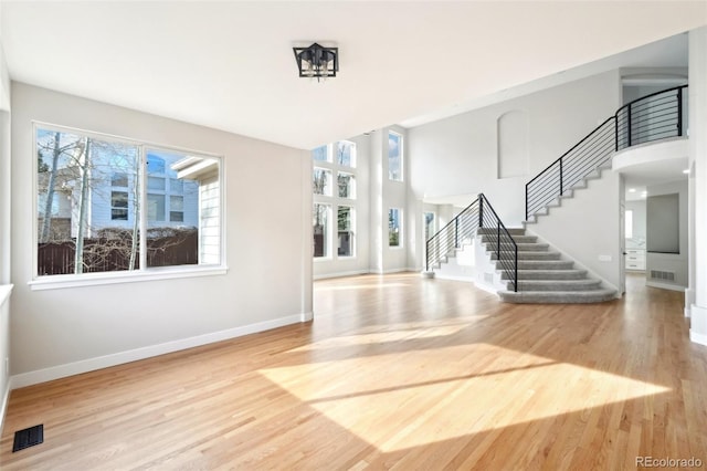 entryway featuring stairs, wood finished floors, and visible vents