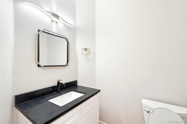 half bath with vanity and toilet