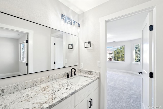 bathroom featuring vanity and baseboards