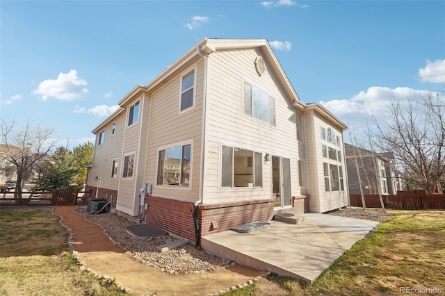 back of property with a lawn, central AC, a patio, and fence