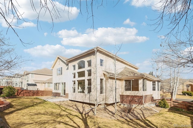 view of property exterior featuring a patio area, a lawn, and fence