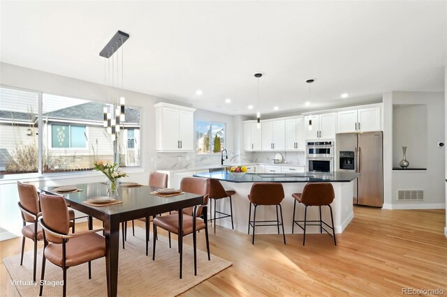 5352 Brookside Dr, Broomfield, CO 80020 - dining space featuring light wood-style floors and recessed lighting