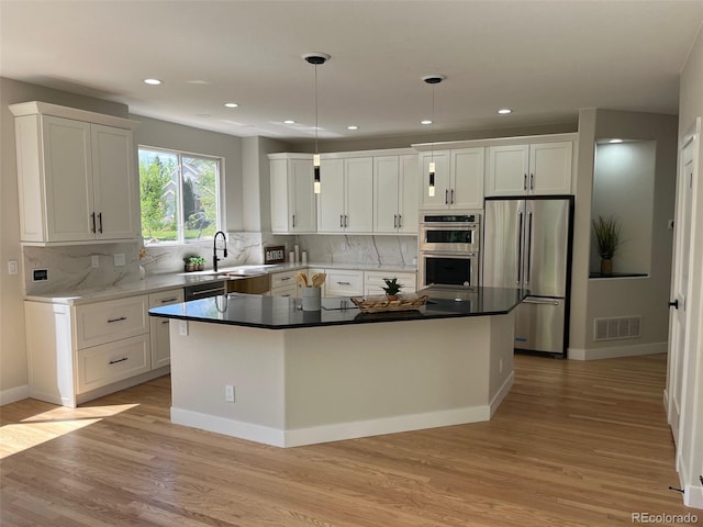 5352 Brookside Dr, Broomfield, CO 80020 - kitchen featuring stainless steel appliances, light wood finished floors, white cabinetry, a sink, and recessed lighting