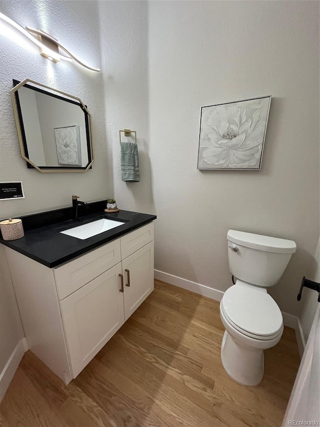 5352 Brookside Dr, Broomfield, CO 80020 - bathroom with wood finished floors, baseboards, vanity, and toilet