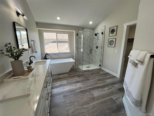 5352 Brookside Dr, Broomfield, CO 80020 - bathroom featuring lofted ceiling, a marble finish shower, a freestanding bath, vanity, and a spacious closet