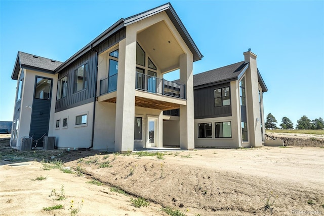 back of property with a balcony