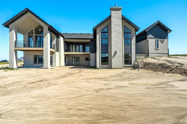 back of property with a balcony