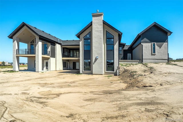 back of house with a balcony